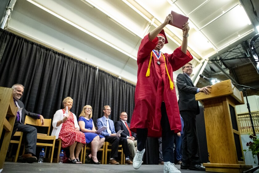Jorge Velasquez raises his diploma high above his head in celebration as the Willmar High School class of 2022 held its commencement ceremony at the Willmar Civic Center on Sunday, June 5, 2022.