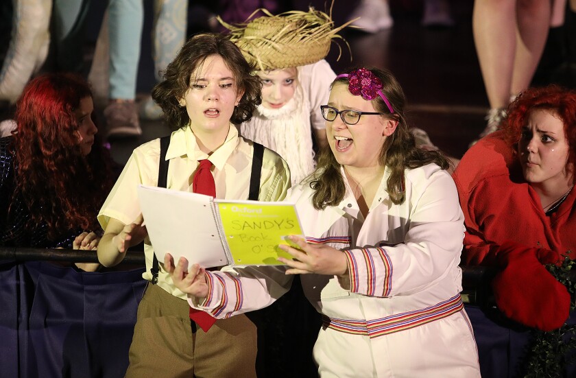 Spongebob, played by Gwen Hall, left, and Sandy, played by Jacqueline Stumpf, look over Sandy’s notes during a scene