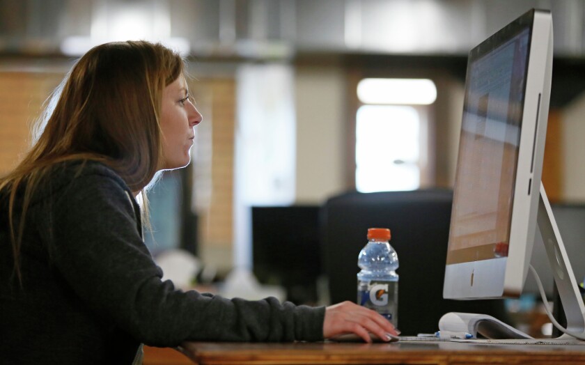 College students Liz Hayden and Alia Kopischke are doing internships at DogIDs in downtown Fargo.David Samson / The Forum