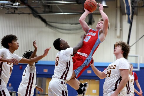 Player shoots over defense.