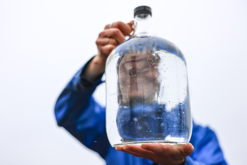 artist on Lake Superior beach unsettled cloudy rainy day