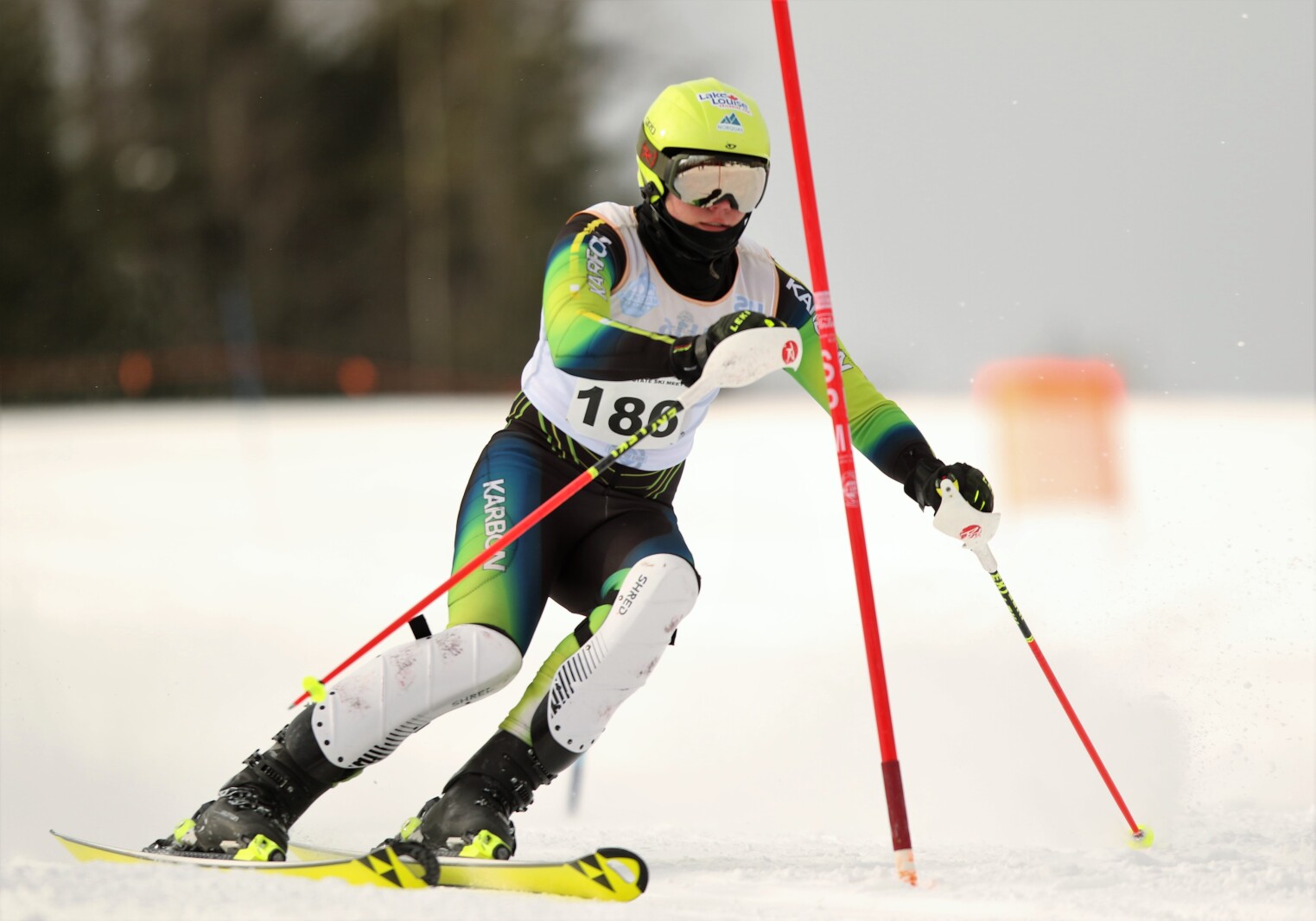 A downhill skier approaches a gate.