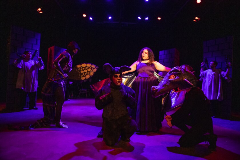 The dragon, played by Madison Anderson-Wilson, interacts with a terrified Donkey, played by Alex Vasquez, during a dress rehearsal of Shrek the Musical at the Barn Theatre on Saturday, June 4, 2022.