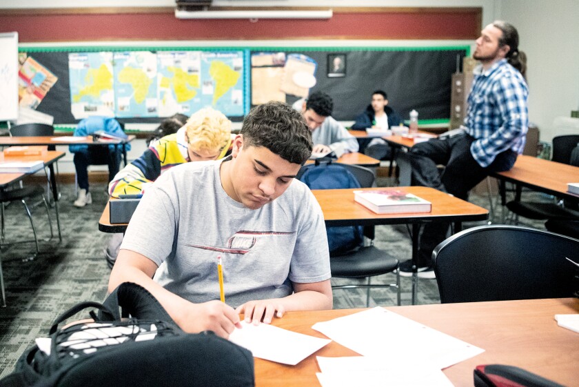 Tenth grader Dominic Blayon writes his letter to Ukrainian teachers and students during a class at the Area Learning Center on Wednesday, April 20, 2022, in Steve Burrows' classroom.