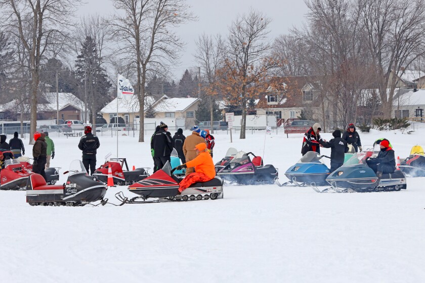 Scorpion snowmobiles and their owners on Serpent Lake.