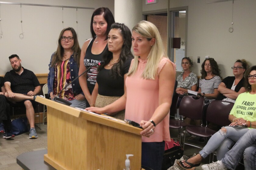 Allie Ollenburger, an organizer with the Recall Fargo School Board group, stands with others to announce the group has procured enough signatures to begin the process of a special election on Tuesday, Aug. 24.jpg