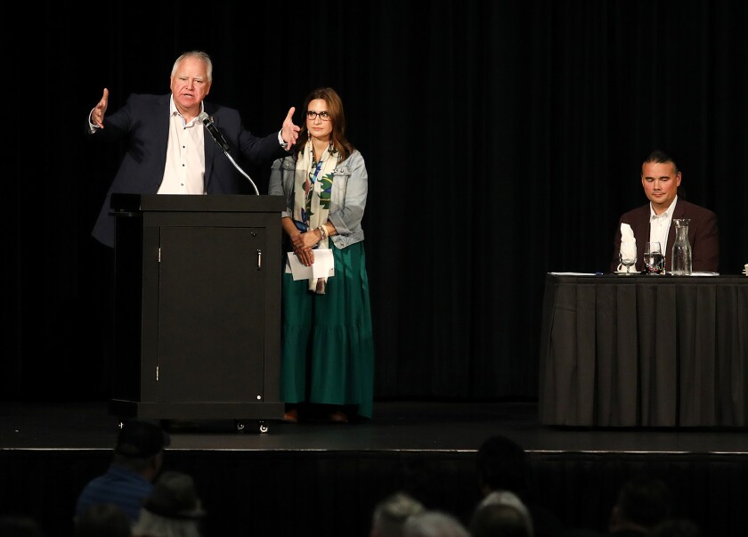 Minnesota Gov. Tim Walz, left, talks about trying to right a wrong while Lt. Gov. Peggy Flanagan, center, and Bryan Newland, U.S. Department of the Interior Assistant Secretary for Indian Affairs, listen during the Reclamation Ceremony