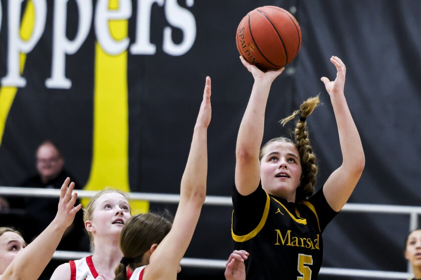 high school girls play basketball