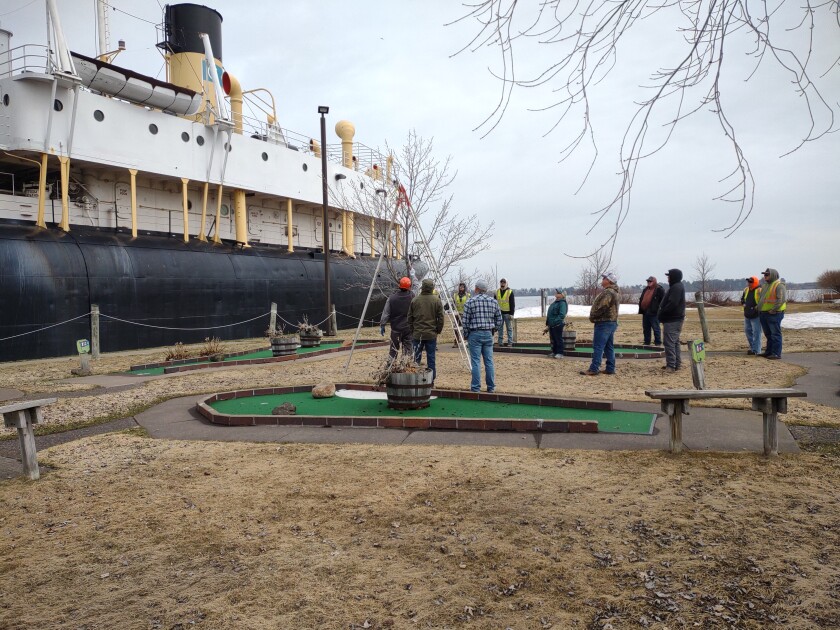 Seminar participants gather around a red maple to evaluate the tree Thursday, April 27, 2023, to determine the best cuts to promote balance in the crown.