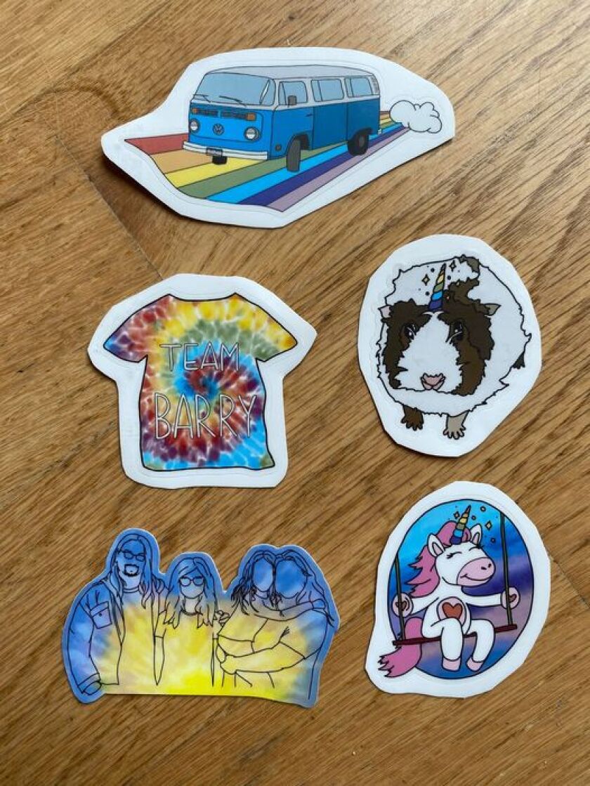 Five stickers displayed on a wood table.
