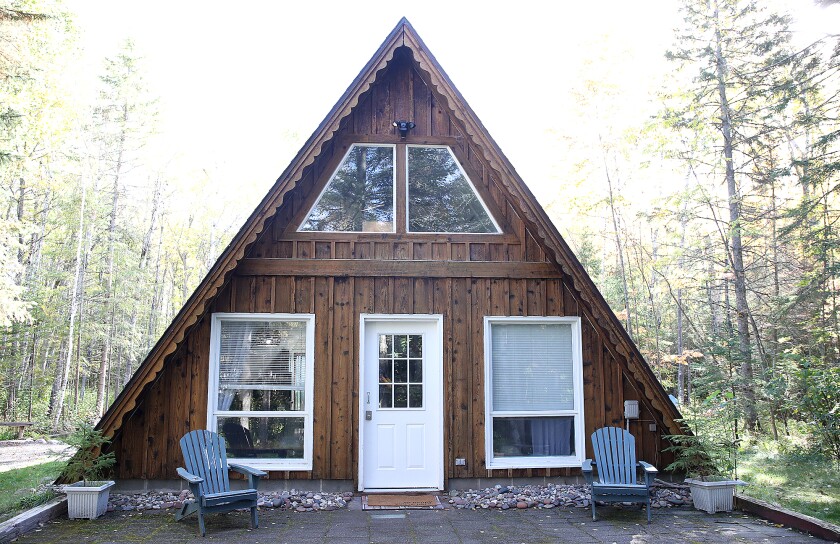 The fixed up A-frame sits in the woods near Herbster