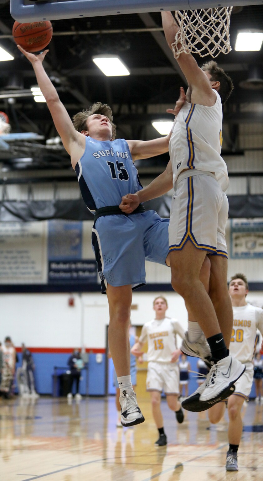 Superior’s Jake Kidd (15) collides with Esko’s Makoi Perich (3) as he scores