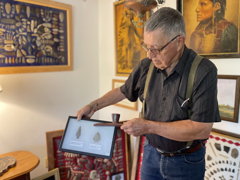 Dickinson resident Steve Yost holds Native American artifacts in his home.