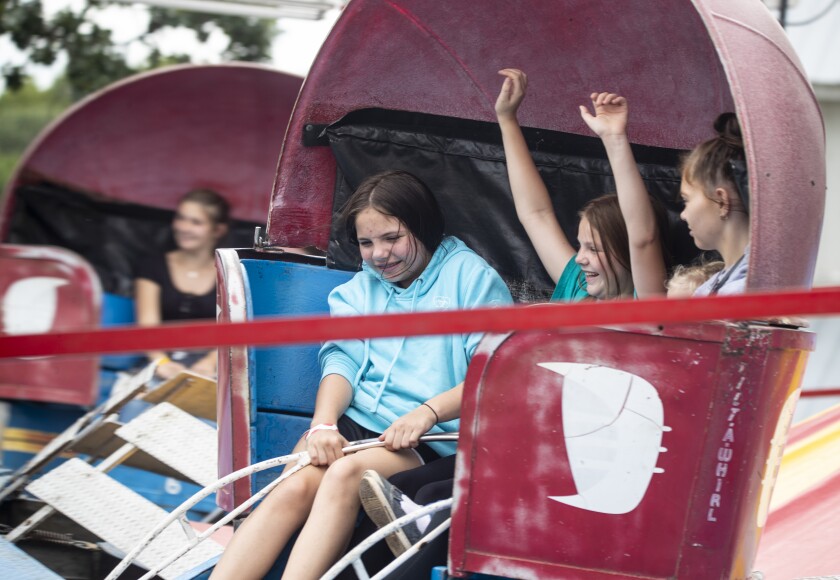 Thrill-seekers ride the tilt-a-whirl at the Kandiyohi County Fair during the final day of the fair on Saturday, August 13, 2022.
