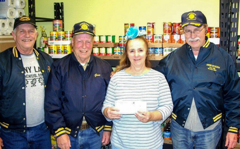 Cheri Westphal of the Hackensack Area Food Shelf receives a check for $2,000 from the Backus American Legion's charitable gaming program. From left are 1st vice commander Bill Taylor, commander Eugene Gagnon, Westphal and adjutant and gambling manager Don Van Vorst. Submitted Photo
