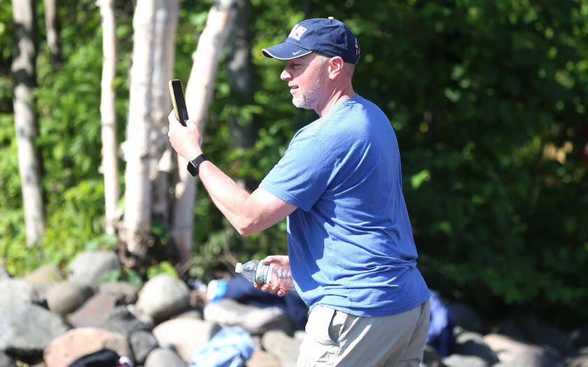 Man uses cellphone to record a visual