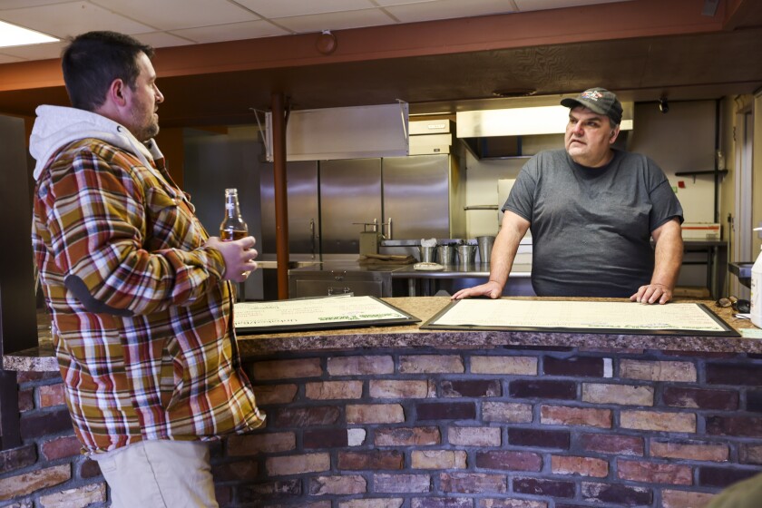 People getting pizza restaurant ready to open