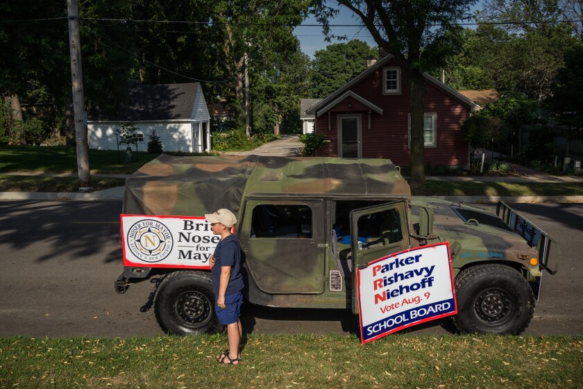 Photos Supporters for opposing school board candidates rally at the