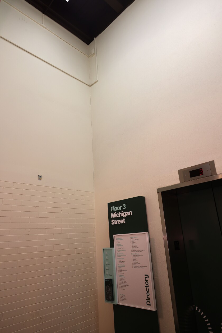 Small mysterious handprint above elevator