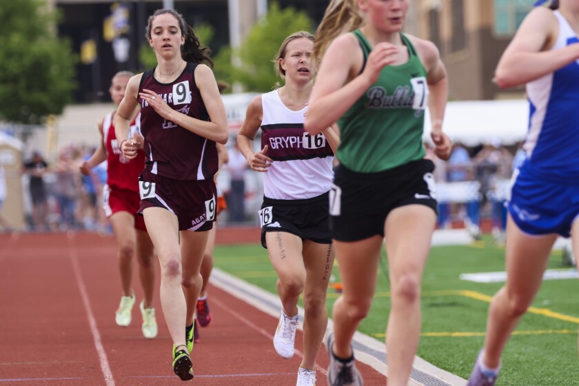 Athletes compete in track and field events at outdoor stadium