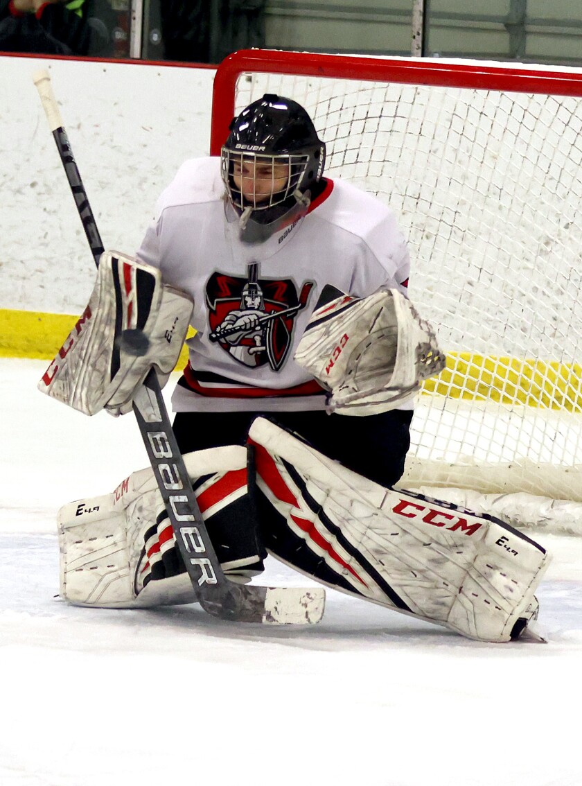 Worthington goalie Steven Adams reaches up to catch the puck during a game with the visiting Waseca Bluejays Thursday night. Tim Middagh / The Globe