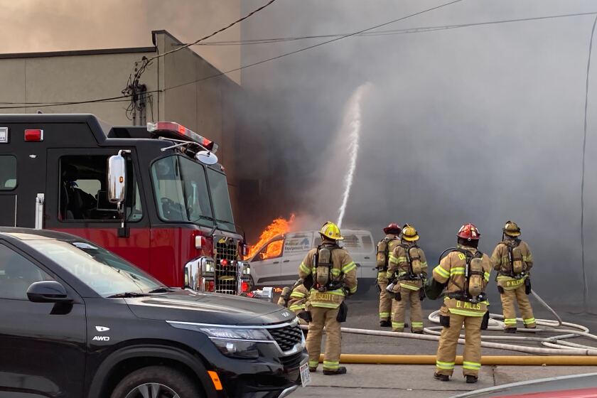 Firefighters Battle Blaze At Central Hillside Medical Equipment Business - Duluth News Tribune 2 Firefighters spray water on burning building