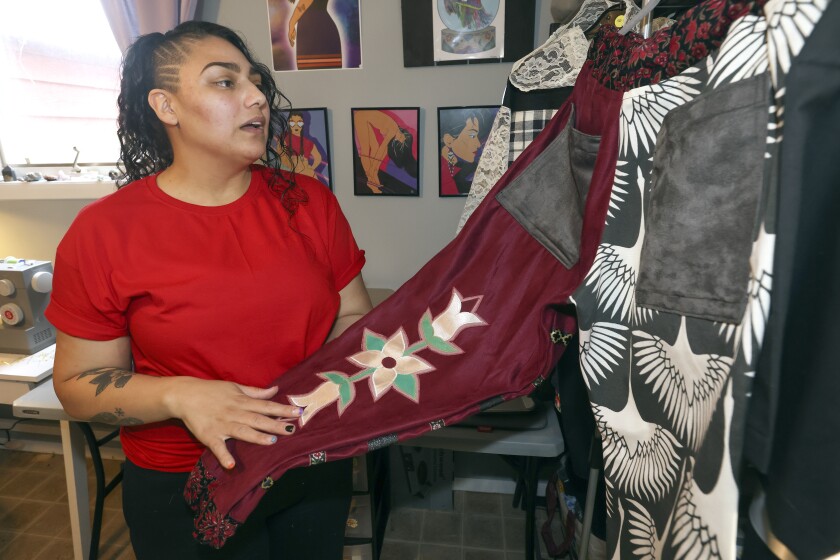 Amber Buckanaga works on her clothing designs.