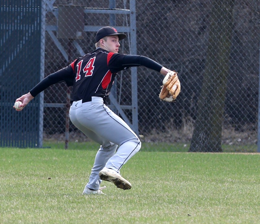 Worthington Trojans center fielder Isaiah Nobel throws a cough ball to second base to stop the Fairmont Cardinals from advancing the runners during a Thursday evening game.