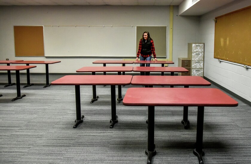 Kayla Mielitz lines up the tables in her new classroom on Thursday afternoon at Hanson School in Alexandria. Mielitz is the first teacher to move into her permanent classroom while construction continues in other parts of the school. (Matt Gade / Republic)