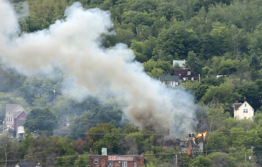 Duluth firefighters shoot water from the bucket on Tower No.1