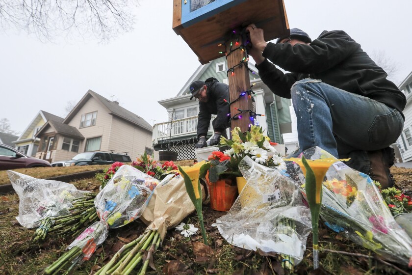 Community members gather to light the Barry home in the East Hillside neighborhood of Duluth