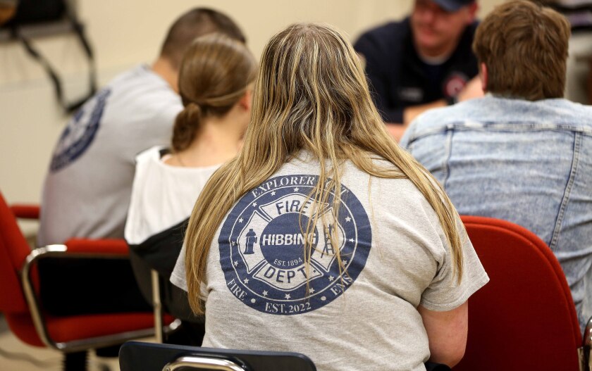 High School student wearing a Hibbing Fire Department Explorer Post T-shirt