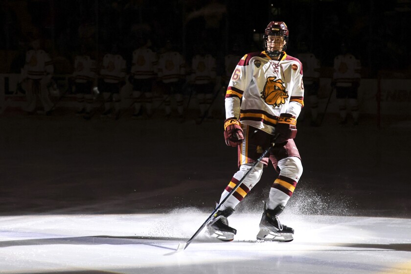college men play ice hockey