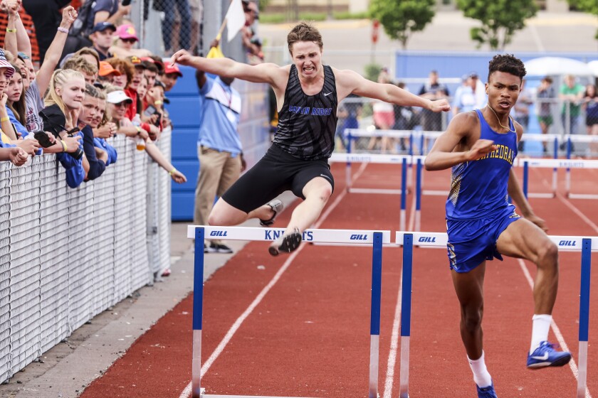 Athletes compete in track and field events at outdoor stadium