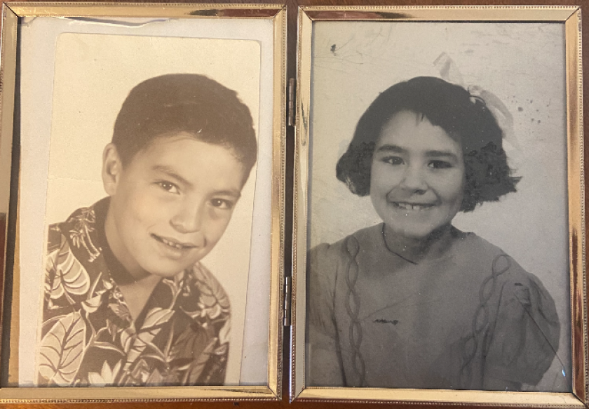 Old photos show a young boy and a young girl.