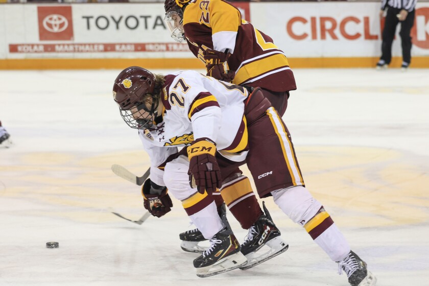 college men play ice hockey