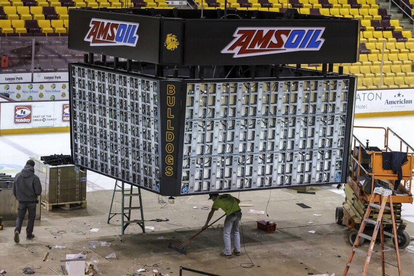 workers install new scoreboard