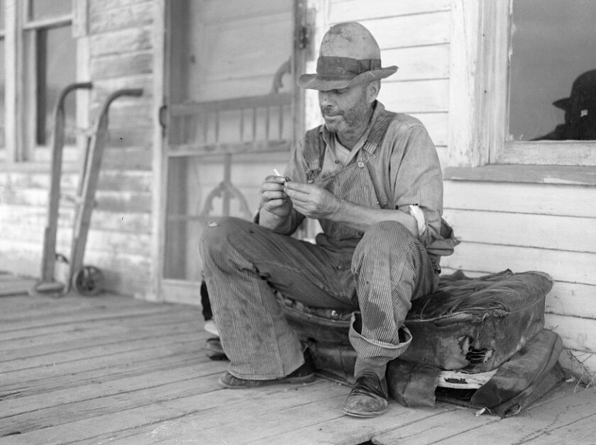 Photograph entitled Waiting for better times J. Huffman of Grassey Butte, ND sits in front of his closed store in 1936 Library of Congress.jpg