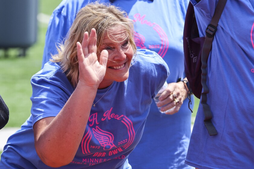 High school athletes compete in track and field events at outdoor stadium