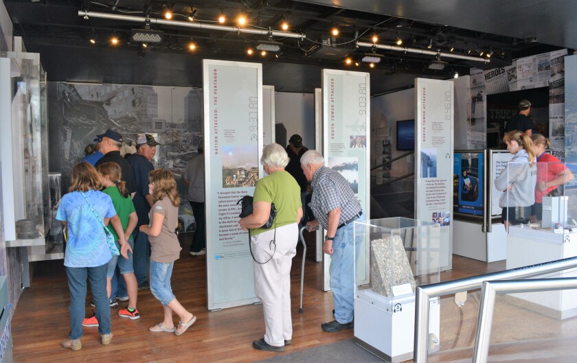 People of all ages walk through the 9/11 Never Forget mobile exhibit that is currently on display at the Douglas County Fair. The museum on wheels commemorates one of the most tragic and heroic days in American history, Sept. 11, 2001. (Celeste Edenloff | Echo Press)