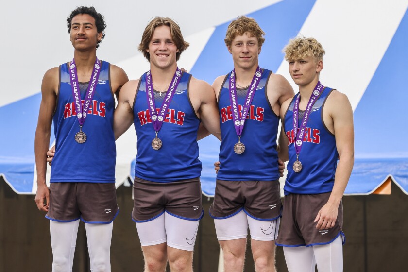 Athletes compete in track and field events at outdoor stadium