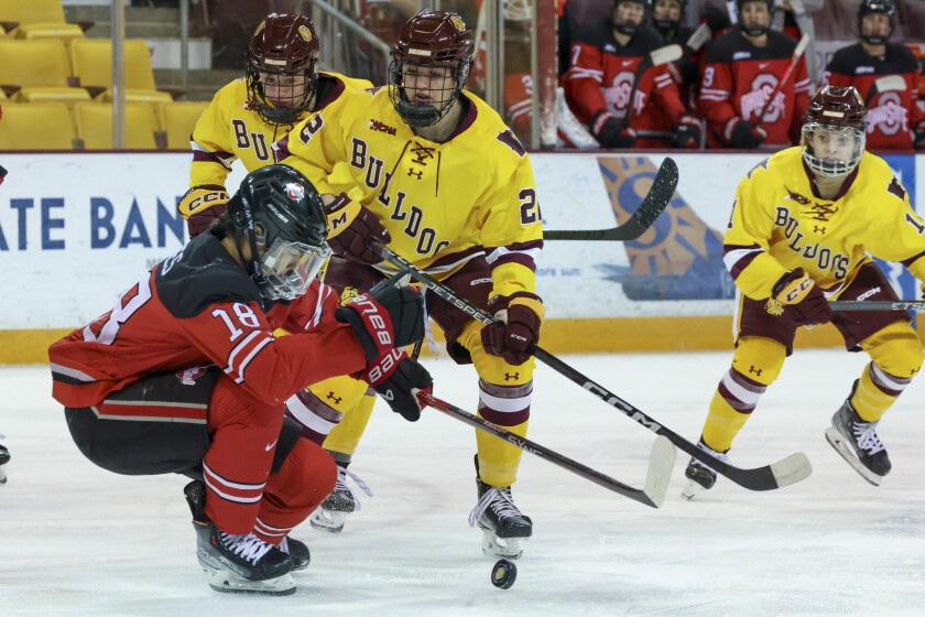 college women compete in hockey game