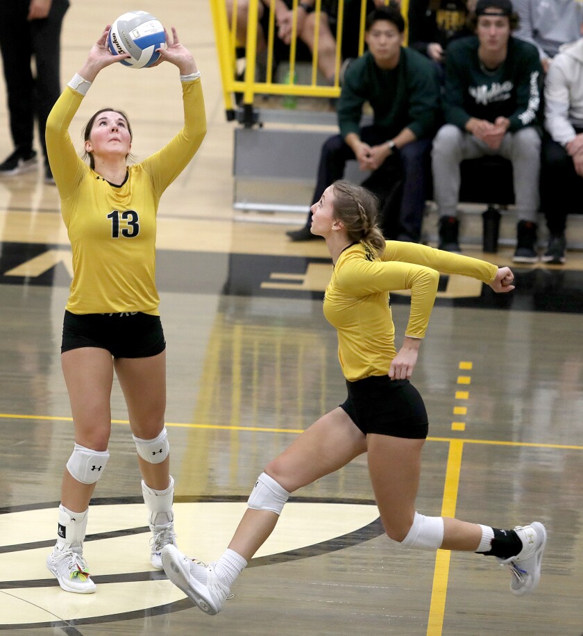 UW-Superior’s Cassy Teff (13) sets the ball for Ella Kapus (18)