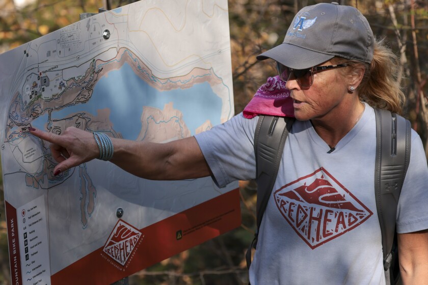 Woman using maps and hiking trails