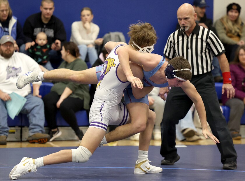 Wrestler takes down opponent.