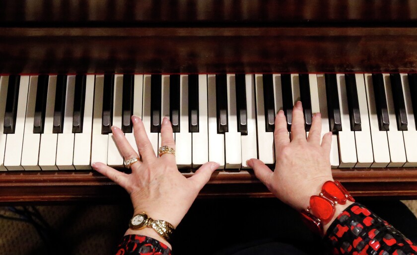 Wanema Wieczorek practices the piano on Tuesday afternoon at the Carnegie Resource Center in Mitchell. Wieczorek will be performing for the Christmas at the Carnegie show. (Matt Gade/Republic)