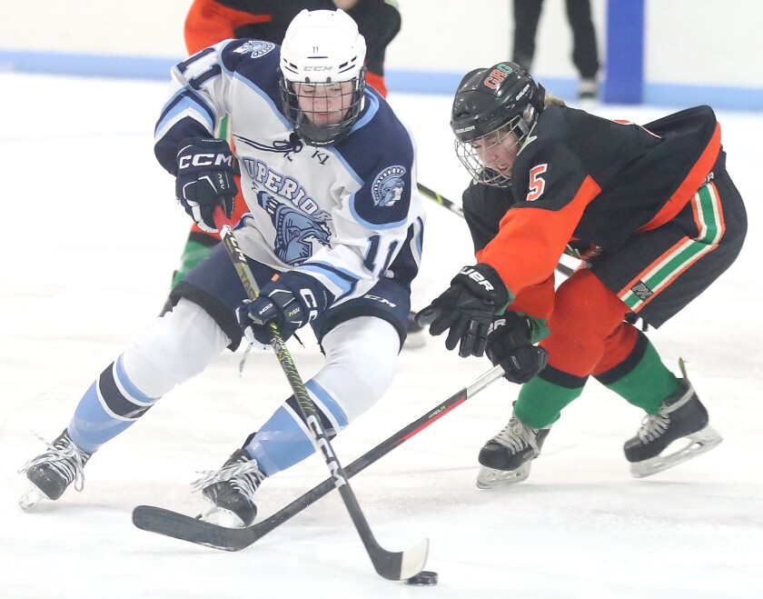 Superior’s Makaela Reinke (11) skates around Grand Rapids-Greenway’s Cali Madsen (5)