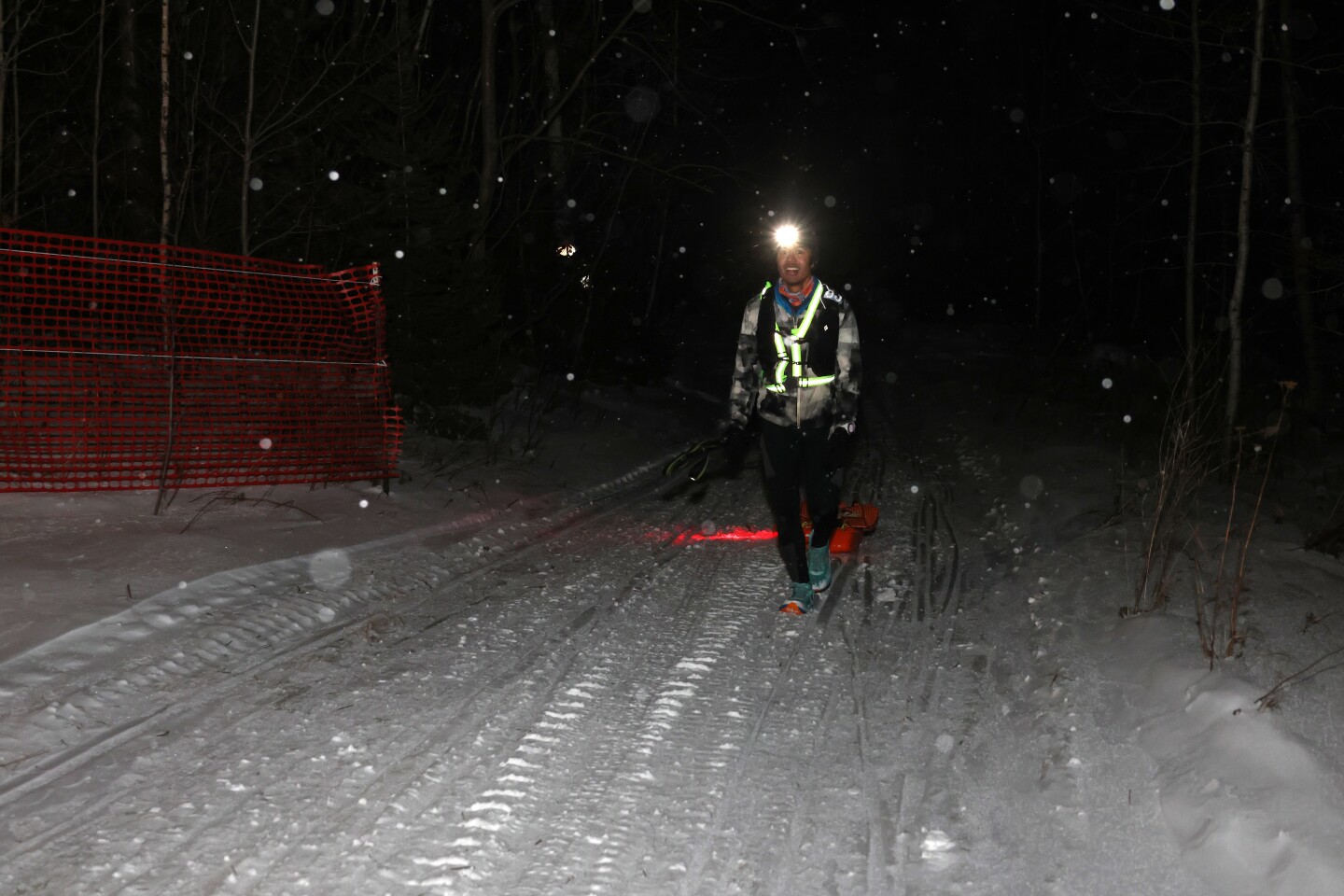Ultramarathoner hikes along snowy trail