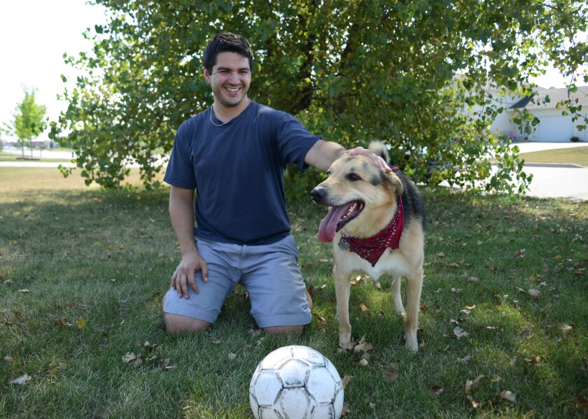Patrick Bailey sits with his 5-year-old dog Lou