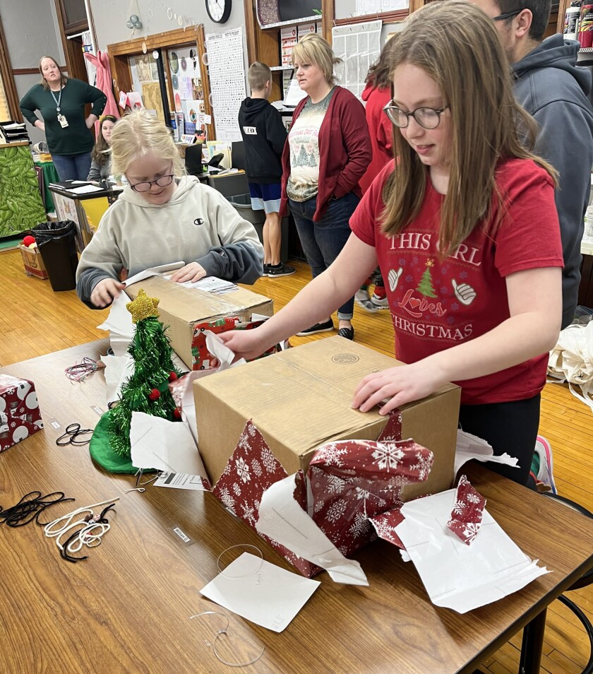 Students at Ellsworth Public School open presents from the Share Tree on Tuesday, Dec. 20, 2022.